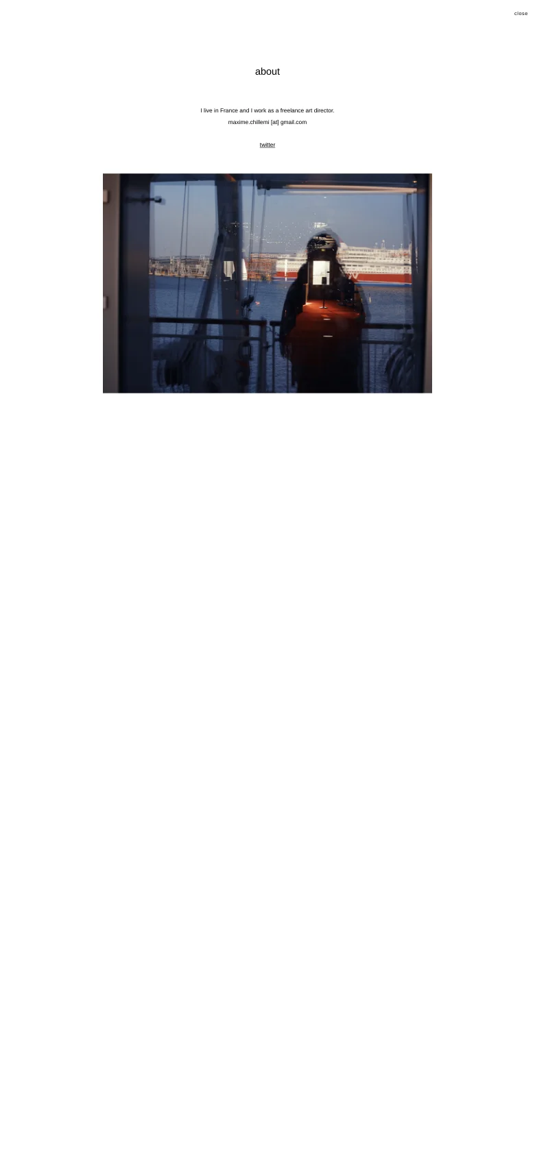 The mobile version maintains the minimalist white aesthetic and centered text layout. The large hero image of a silhouette reflected in a window is scaled to fit the narrower screen, and the navigation elements are condensed for a vertical view.