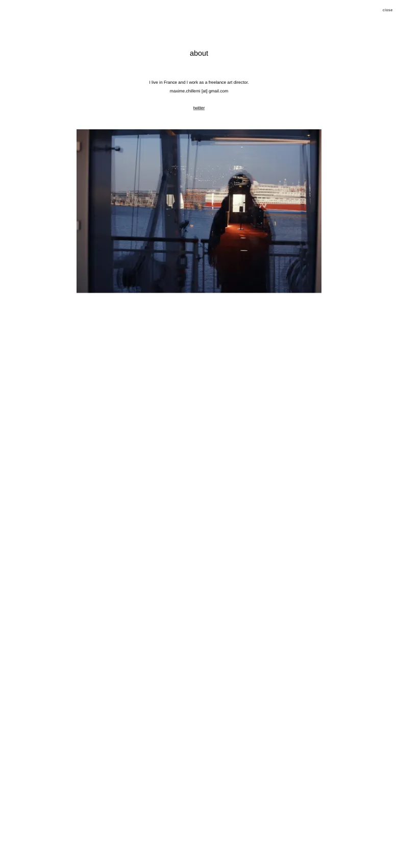 The mobile version maintains the minimalist white aesthetic and centered text layout. The large hero image of a silhouette reflected in a window is scaled to fit the narrower screen, and the navigation elements are condensed for a vertical view.