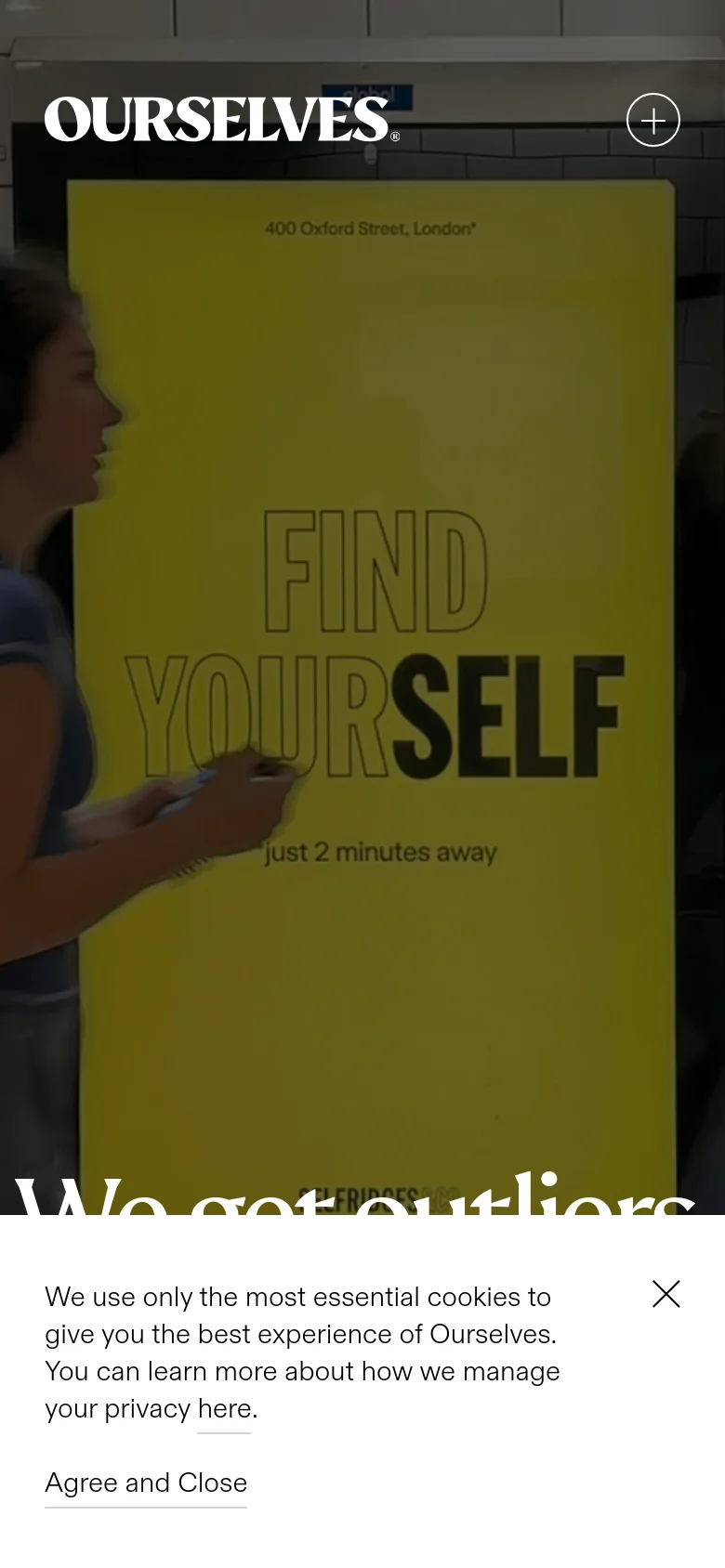 The mobile version presents a vertically oriented layout with a close-up, slightly darkened hero image featuring the text 'FIND YOURSELF' on a yellow background. The 'OURSELVES' logo and a plus icon are at the top, and the cookie consent banner is repositioned at the bottom of the screen.