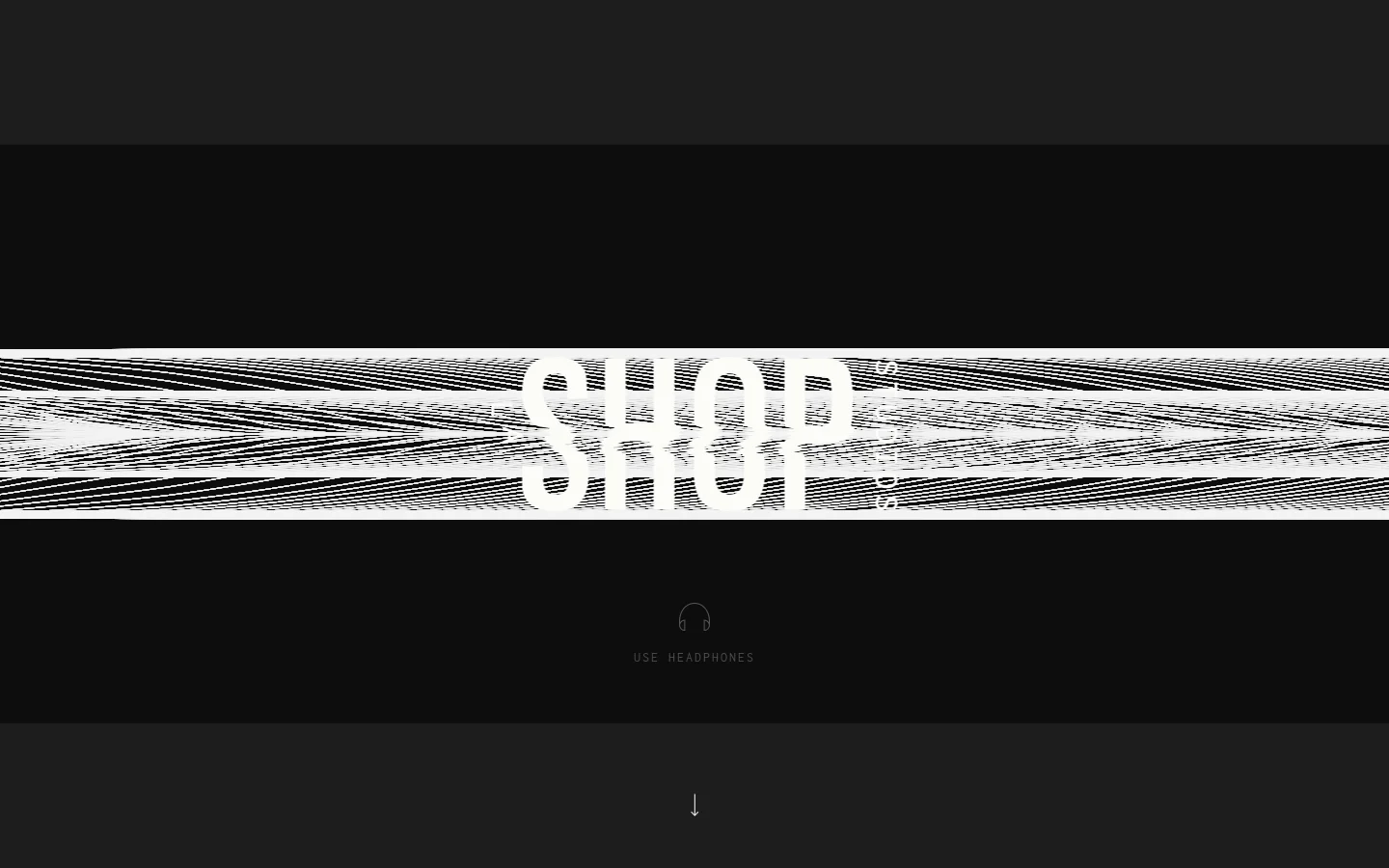 The desktop homepage features a minimalist dark theme with a large, stylized white text graphic reading 'SHOP STUDIOS' stretched across a textured, horizontal white band. Below the graphic, a small headphone icon is centered above the text 'USE HEADPHONES,' and a downward-pointing arrow sits at the bottom of the screen to indicate scrolling.