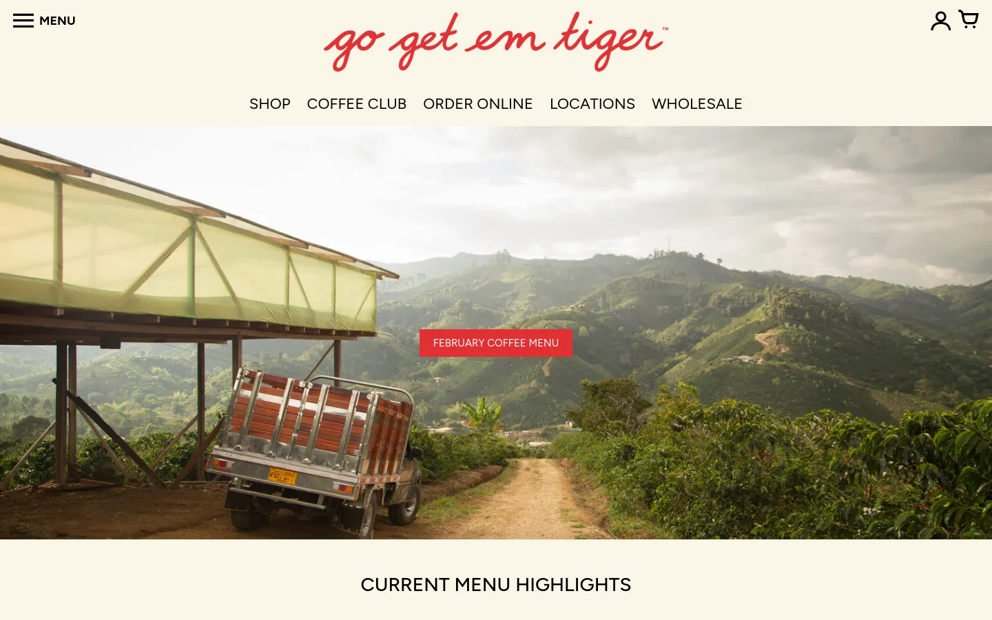 The desktop homepage features a large hero image of a coffee farm landscape with a red button labeled 'FEBRUARY COFFEE MENU'. Below, the 'CURRENT MENU HIGHLIGHTS' section displays coffee products in a grid layout with large product photography, names, and tasting notes. The site uses a clean, minimalist design with a cream background and red accents.