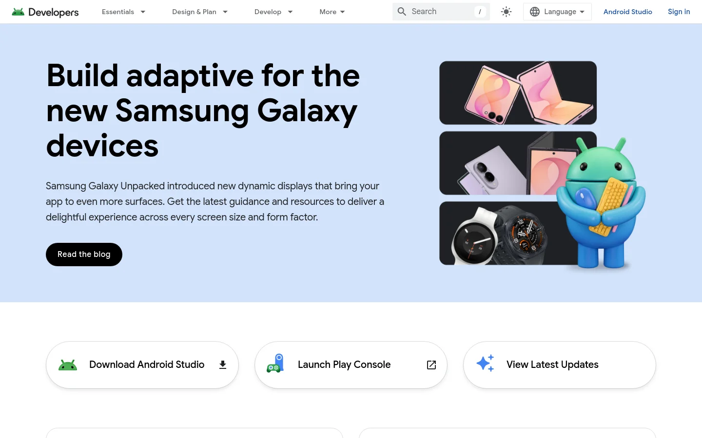 The Android Developers homepage features a light blue hero section with a large headline about building adaptive apps for Samsung Galaxy devices. To the right, a graphic shows various Samsung devices and a 3D Android mascot holding a waffle. Below the hero, three large white buttons provide quick links to download Android Studio, launch Play Console, or view latest updates.