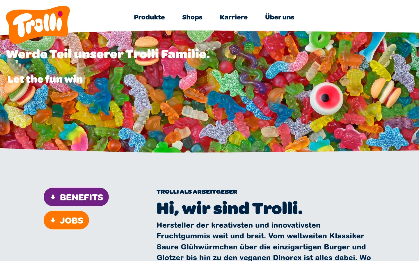 The desktop page features a white header with the Trolli logo and navigation links for Produkte, Shops, Karriere, and Über uns. A large hero banner displays a colorful collage of gummy candies with the white text 'Werde Teil unserer Trolli Familie. Let the fun win'. Below, a light gray section contains two rounded buttons labeled 'BENEFITS' in purple and 'JOBS' in orange, next to the headline 'Hi, wir sind Trolli.'