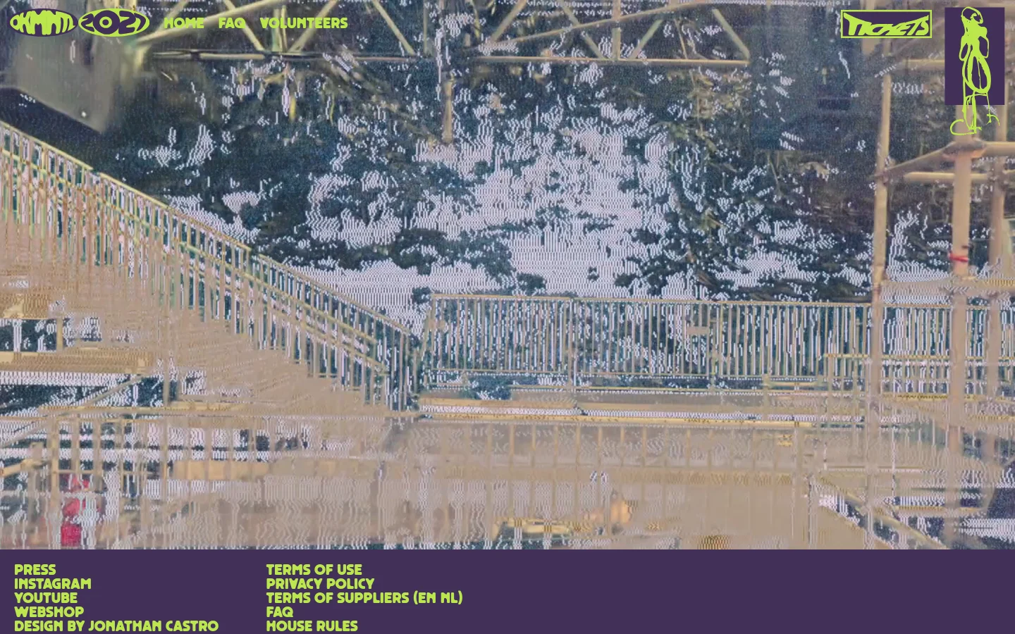 The Dekmantel Festival homepage features a grainy, lo-fi aesthetic with a background image of an industrial structure and trees. A navigation menu at the top includes links for Home, FAQ, and Volunteers, alongside a prominent 'Tickets' button and a stylized logo. The footer contains links for Press, Instagram, YouTube, Webshop, and legal information in bright lime green text against a dark purple background.