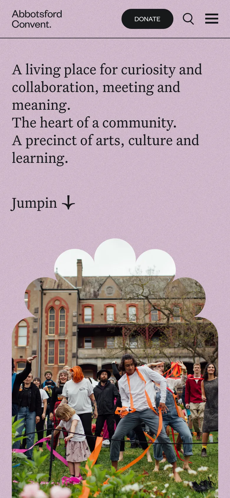 The mobile version maintains the purple background and large serif headlines but uses a condensed layout. The header is simplified with a 'Donate' button, a search icon, and a hamburger menu icon on the right. The scalloped photo of people in front of the heritage building remains the central visual element at the bottom of the screen.