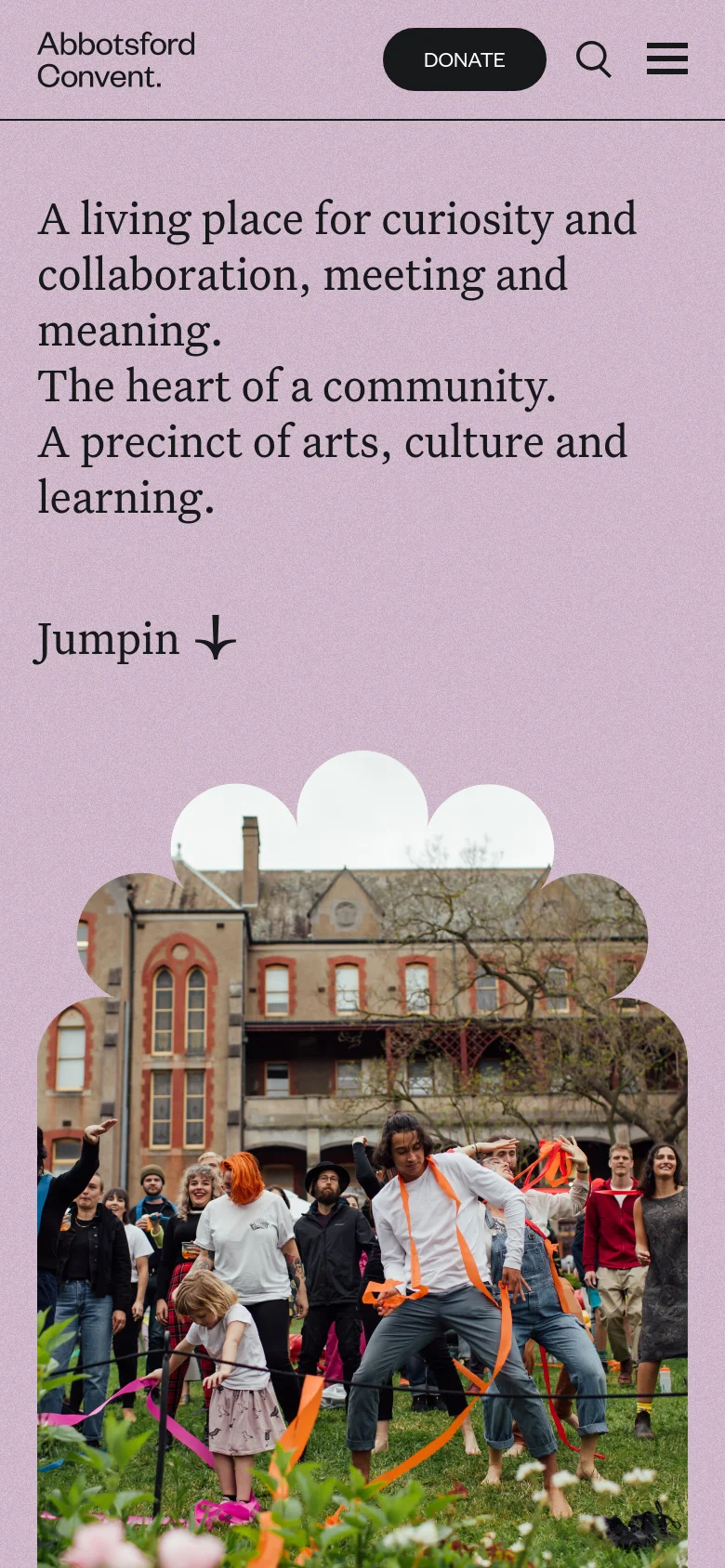 The mobile version maintains the purple background and large serif headlines but uses a condensed layout. The header is simplified with a 'Donate' button, a search icon, and a hamburger menu icon on the right. The scalloped photo of people in front of the heritage building remains the central visual element at the bottom of the screen.