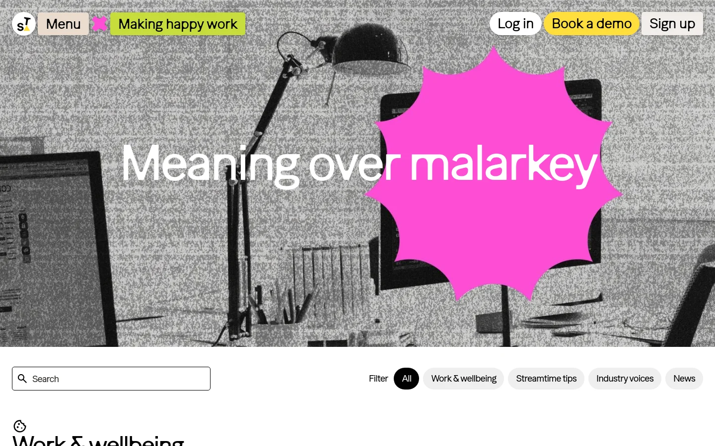 The desktop blog page features a large, grainy black and white hero image of a desk setup with a bright pink starburst shape overlaying the center. The headline 'Meaning over malarkey' is displayed in large white text across the image. Below the hero section, there is a search bar and a horizontal filter menu with categories like 'All', 'Work & wellbeing', and 'Streamtime tips'.