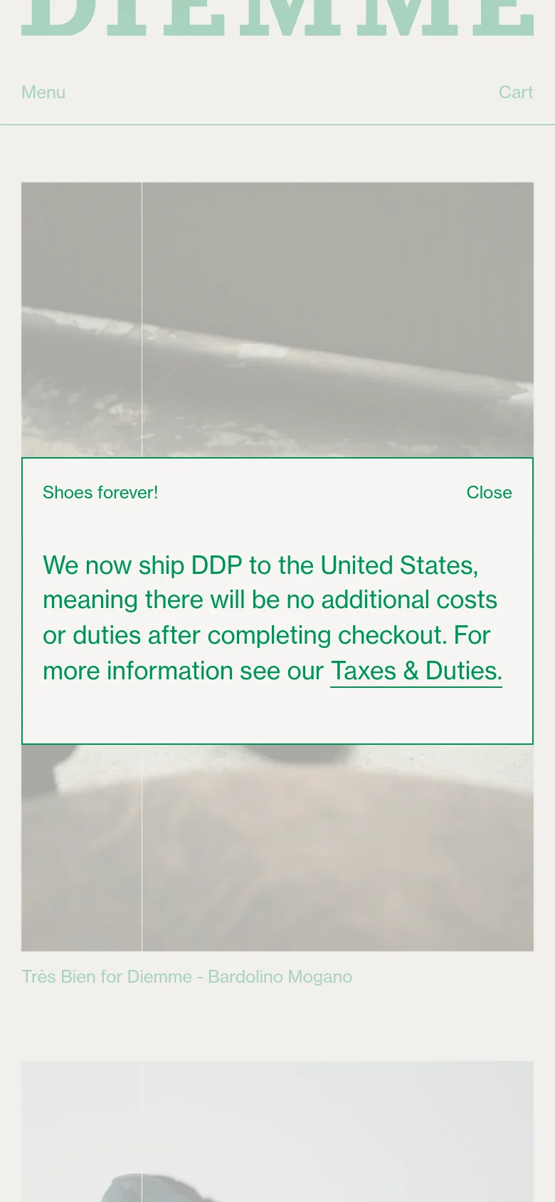 The mobile version simplifies the layout, replacing the wide navigation bar with a 'Menu' button and a 'Cart' icon. The large logo remains prominent at the top, and the shipping notification pop-up is centered over a large product image of leather footwear.