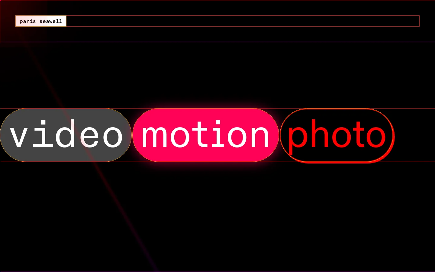 A dark minimalist portfolio landing page for Paris Seawell featuring a black background with thin red accent lines. Three large, pill-shaped buttons labeled 'video' in grey, 'motion' in glowing pink, and 'photo' in red outline are centered horizontally. The top left corner contains a small light grey box with the name 'paris seawell' in lowercase.