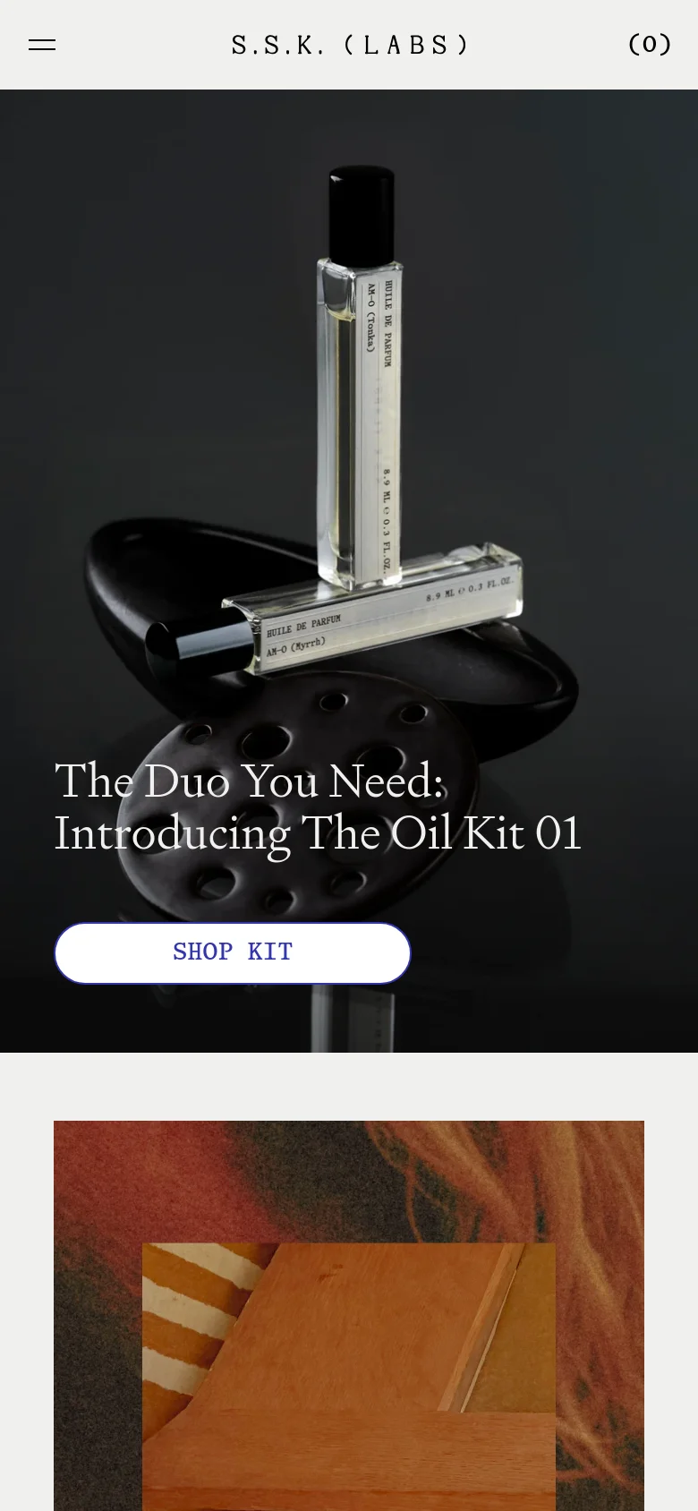 The mobile version presents a single-column vertical layout, starting with a full-width hero image of fragrance vials and the headline 'The Duo You Need: Introducing The Oil Kit 01'. A simplified header contains a hamburger menu icon, the brand name, and a cart indicator. The split-screen desktop hero is replaced by stacked, full-width imagery and text blocks.