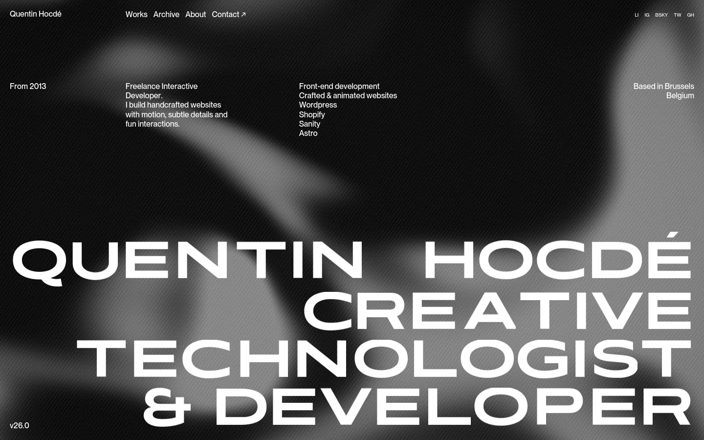 Quentin Hocdé homepage featuring a dark, atmospheric hero section with large, bold white typography reading QUENTIN HOCDÉ CREATIVE TECHNOLOGIST & DEVELOPER. The layout uses a minimalist spread with text elements like Freelance Interactive Developer and tech stacks like Shopify and Astro arranged around a blurred, abstract background.