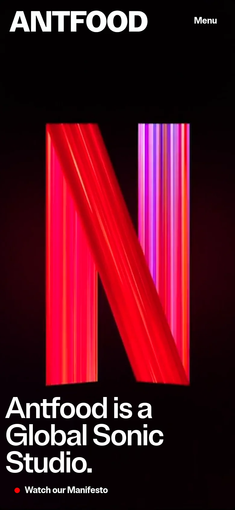 The mobile version uses a vertical layout with a large, vibrant red and purple graphic dominating the upper screen. The headline 'Antfood is a Global Sonic Studio' and the 'Watch our Manifesto' link are stacked vertically at the bottom, and the navigation is condensed into a 'Menu' button at the top right.