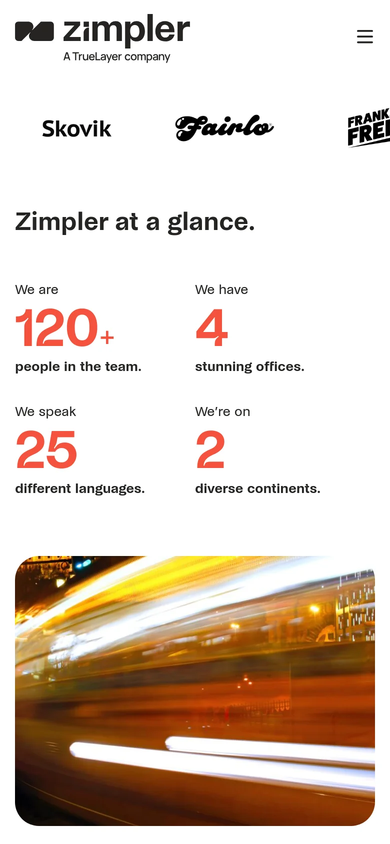 The mobile version presents a simplified vertical layout with a hamburger menu icon in the top right. The partner logos and statistics section are stacked vertically, with the large orange numbers and text centered to fit the narrow screen. The primary headline 'Zimpler at a glance.' remains prominent above the statistics.