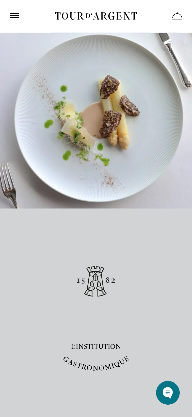 The mobile version presents a vertically stacked layout optimized for small screens. The header contains a hamburger menu, the brand logo, and a profile icon, while the hero image of the plated dish spans the width of the screen. A floating chat bubble icon is visible in the bottom right corner for quick communication.